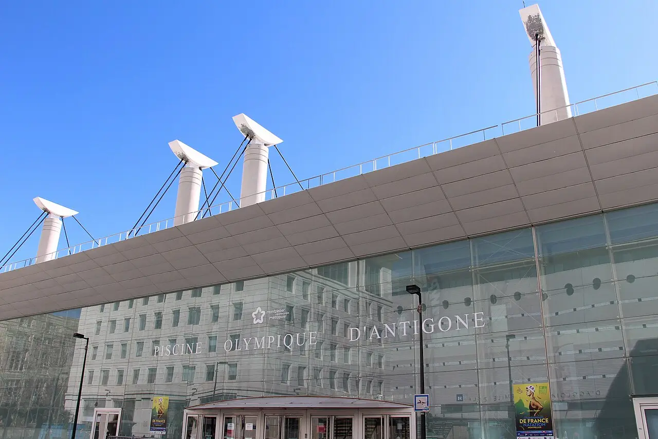 La façade vitrée de la piscine olympique d’Antigone, avec son enseigne, à Montpellier